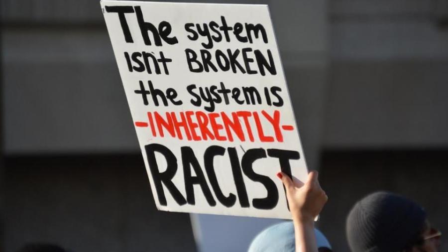 A demonstrator's sign in downtown Phoenix at a May protest. Photo by Richard Amesbury.