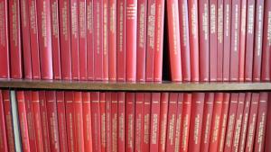 A collection of red books on a shelf