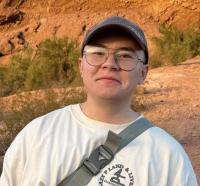 Scout Etterson smiling in front of red rocks
