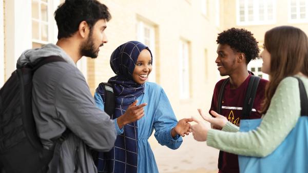 A group of ASU students talk to each other. 
